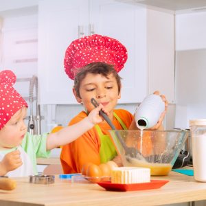 Kids wearing chef hats making Kid-Friendly Recipes together